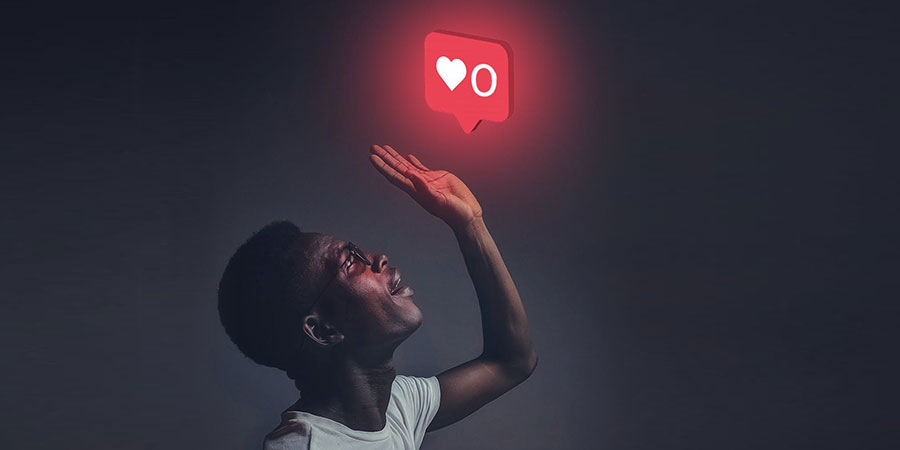 black man raising his left hand in the air and a heart icon above